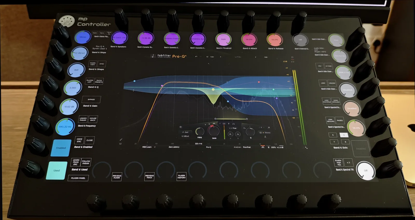 FabFilter Pro-Q 4 open on the MP Controller's 15.6-inch touchscreen with its bands auto-mapped across the 32 endless encoders